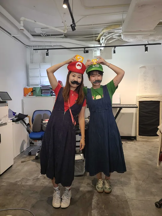 Teammates dressed up as Mario and Luigi for a costume day at the office